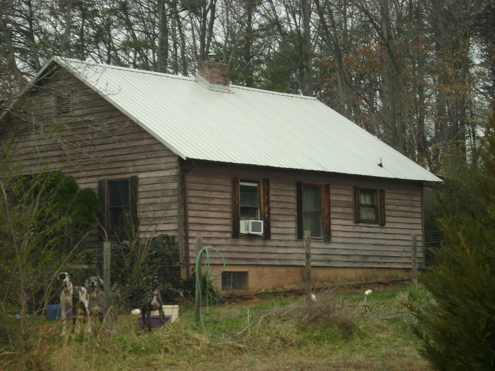 White metal roof on an old wood sided farmhouse, from a Metal Roof Installation job in Killingworth